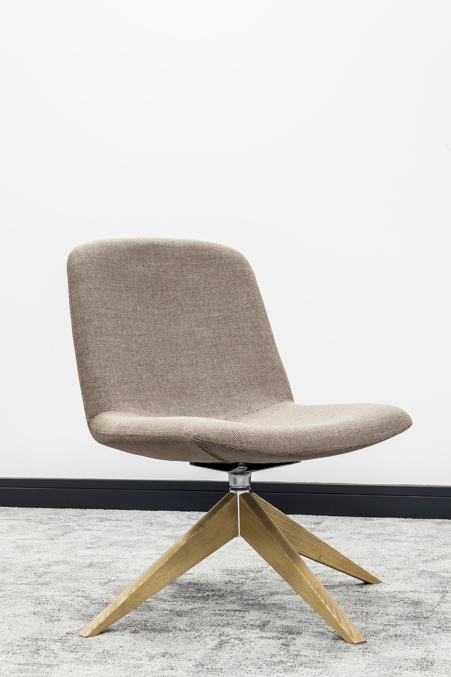 Oatmeal swivel lounge chair on an oak star base
